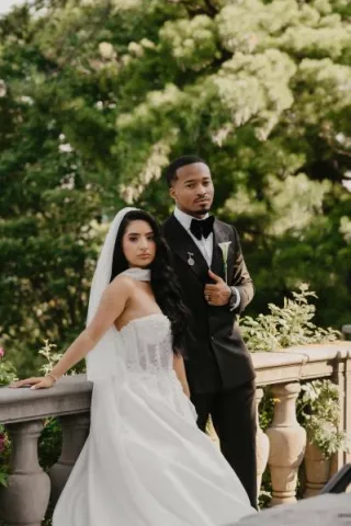 Jenny and Joseph pose side by side in their wedding attire at Villa Terrace
