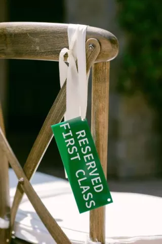 Aviation themed escort card hanging on chair
