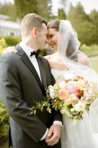 Tom and Clare embrace on their wedding day at Alpine REsort