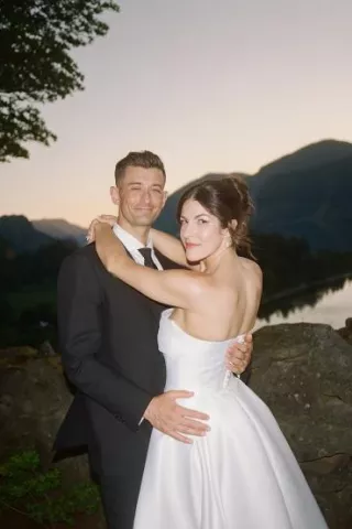 Bride and groom embrace during sunset at The Griffin Hosue