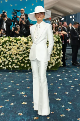 Zendaya wears a custom Louis Vuitton zoot suit, reimagining 1940s menswear with a contemporary twist, honoring the "Superfine: Tailoring Black Style" theme at the 2025 Met Gala.