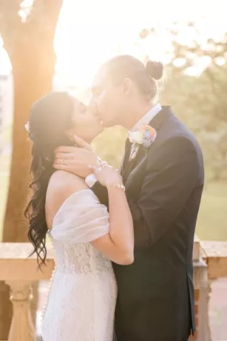 Grant and Shipra pose with golden hour sun illuminating them 
