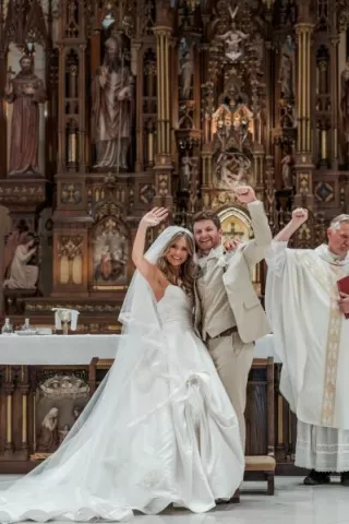 Tess and Tommy wave to their friends and family after exchanging vows 