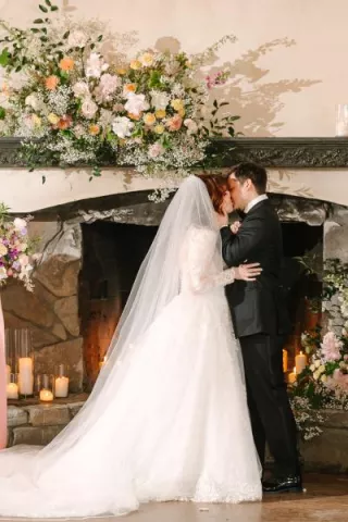 Lilly and Michael share a kiss on their wedding day at Chateau Lil