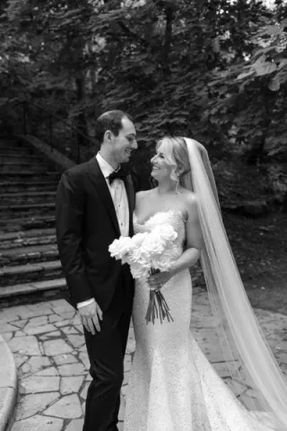 Bride and groom share a loving glance on the grounds outside of Livestock Exchange Ballrooms in Omaha