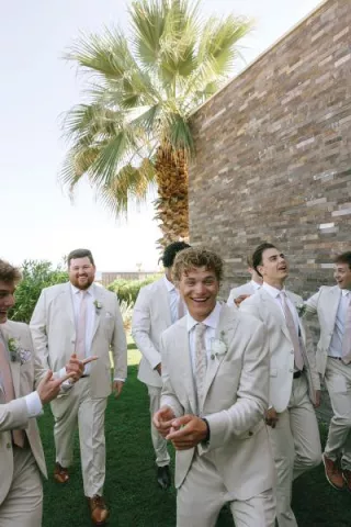 Groomsmen smile and pose playfully 