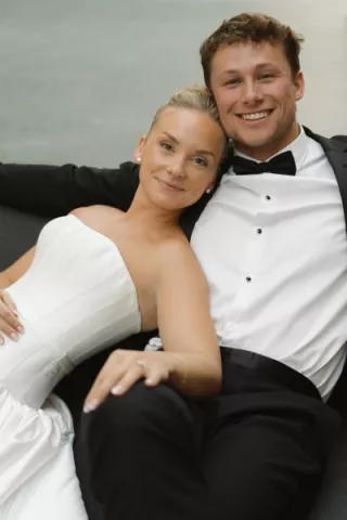 Bride leans on the shoulder of her groom, lounging on their wedding day at The Joslyn