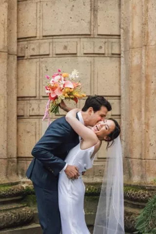 Bright colored florals decorate ecclectic wedding held under the roman rotunda at the Palace of Fine Arts