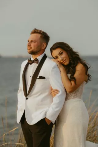 Laney rests her head on Troy's shoulder in their wedding attire 