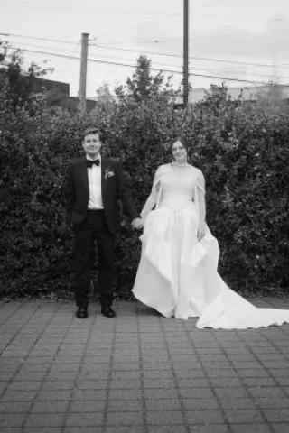 Allie and Max pose side by side on their wedding day
