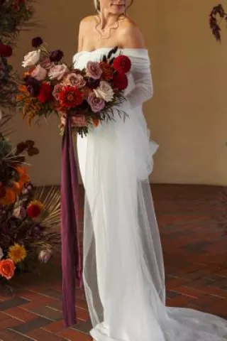 Autumn-inspired wedding shoot at a Tuscany-style winery with rich florals, warm tones, and elegant details.
