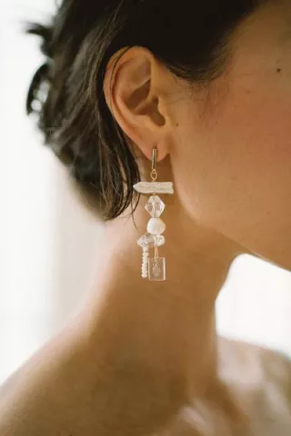 Close-up of a handcrafted glass earring from Rileyhaus featuring a delicate, artisanal design