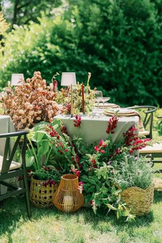 Lush blooms overflow from circular tablescape in editorial at Parties on the Terrace