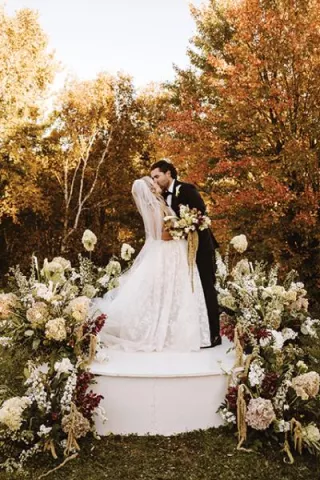 Morgan and Justin kiss at the altar in their wedding day at The Farm Wedding and Event Center