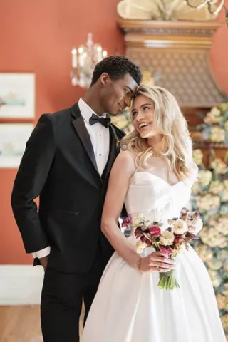 Models pose in an embrace in styled shoot at Maxwell Mansion