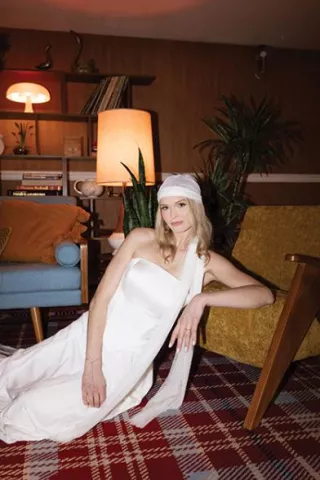 Model poses in retro-chic editorial at Graduate