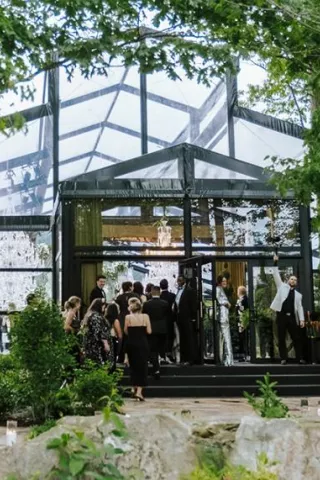 Guests file in to a greenhouse-style venue