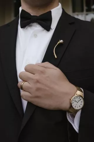 Close up of brooch on lapel of tuxedo