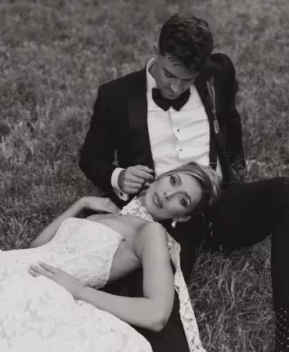 Bride rests her head on the groom's lap on their wedding day at Woods & Co.