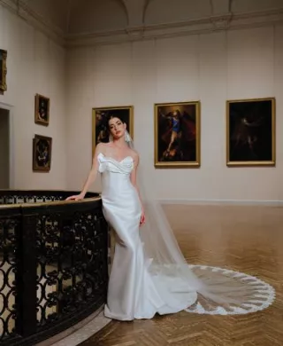Model poses in bridal gown amidst artwork at Minneapolis Institute of Art