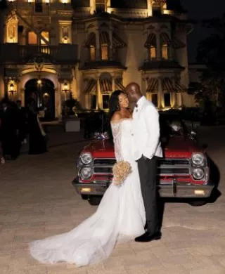 Marcelia and Renwick pose in front of vintage car outside of the Wisconsin Club
