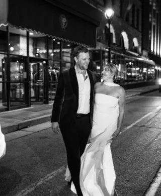 Couple walking out in the street outside of The Pfister Hotel, the location of their welcome party