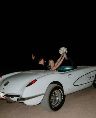 Madison and Sam in their vintage getaway car