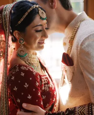 Bride and groom embrace in their traditional Indian garb in wedding day at Lairmont Manor