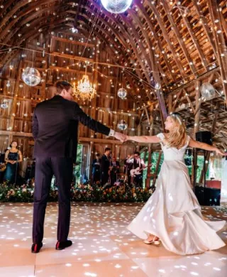 Bride and groom dance together covered in disco lights in reception at Arbor Day Farm 