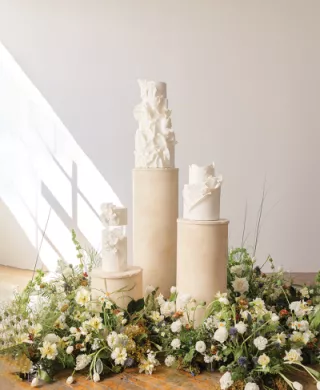 Chic and Elegant Wedding Cakes Displayed Amongst Fresh Florals