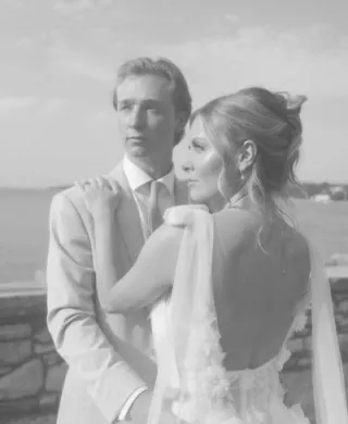 Bride and groom pose on the grounds of Alpine Resort