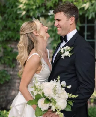 Anna and Grant share a laugh at their lakeside wedding day