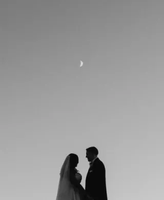 Tsion and Ben stand looking at each other under the moon. 