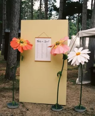 Handmade paper florals around seating chart 