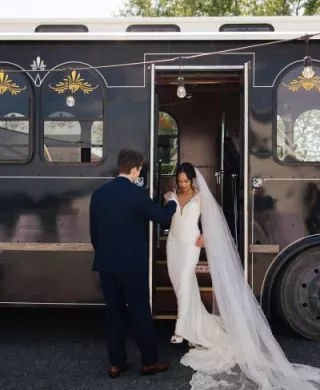 Chonhanh and Nicholas pose on the steps of their wedding day trolley
