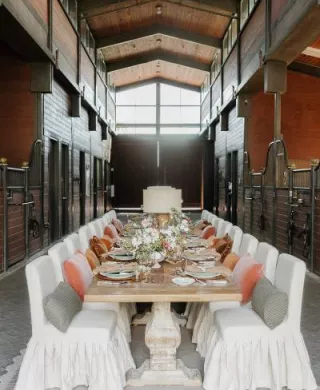 Earthy tablescape in the midst of a horse barn at TERI campus of life