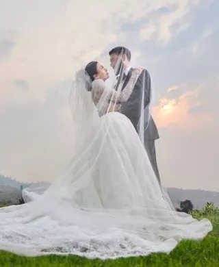 Noelle and Richard embrace as the sun sets behind them on their wedding day at Larc Hill Vineyard