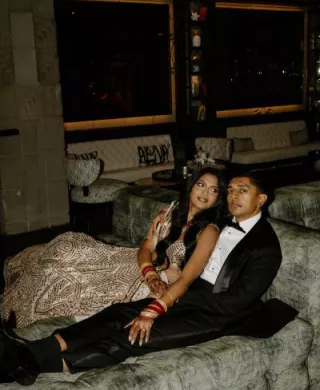 Nikita and Sahil pose before their reception in their opulent attire