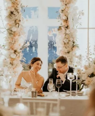 Lauren and William Share a Smile Surrounded by Whimsical Florals