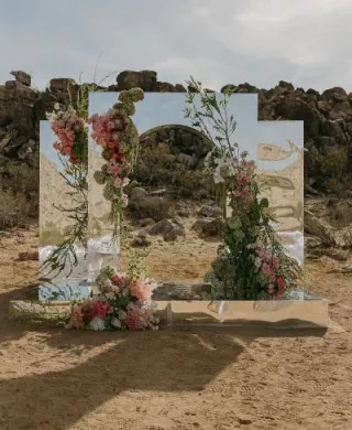 Eclectic desert ceremony space with mirrored altar and vibrant florals at Morada in Joshua Tree