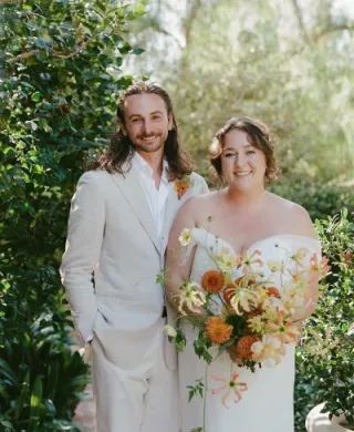 Bride and groom pose, smiling side by side in Santa Fe wedding day at private estate
