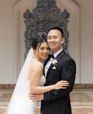 Thao and Corey smile and pose on their wedding day at Rancho Las Lomas