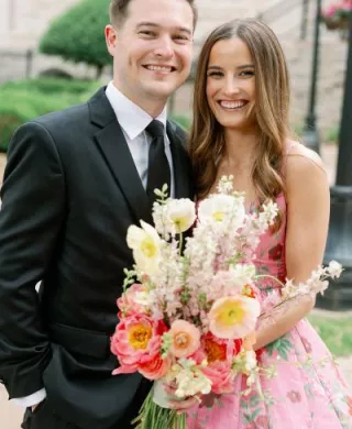 Bride and groom pose together on their winning wedding day