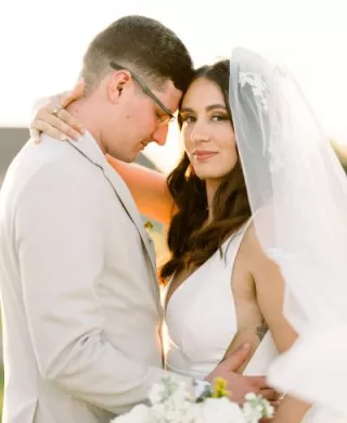Close up of the bride and groom in an embrace with their foreheads pressed together on the grounds of Bella Terre Vineyard