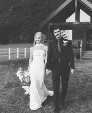 Ashley and Jaxson walk hand in hand on the grounds of Wind Mountain Ranch