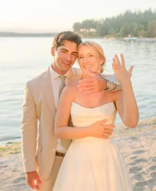 Courntey and Alden pose by the lake on their wedding day