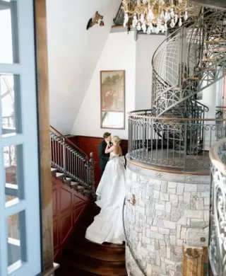 Lindsey and Scott pose on the staircase of Chateau de Harpe