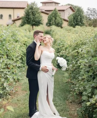 Layne and Nick pose in their wedding attire on the grounds of  Villa Bellezza