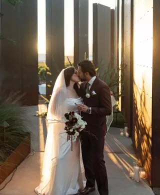 Jacquie and Ryan share a kiss amidst the modern structures at Los Milics Vineyards