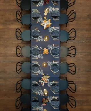 Bold tablescape featuring dark navy tones and metallic accents in one long table at Ellsworth Block